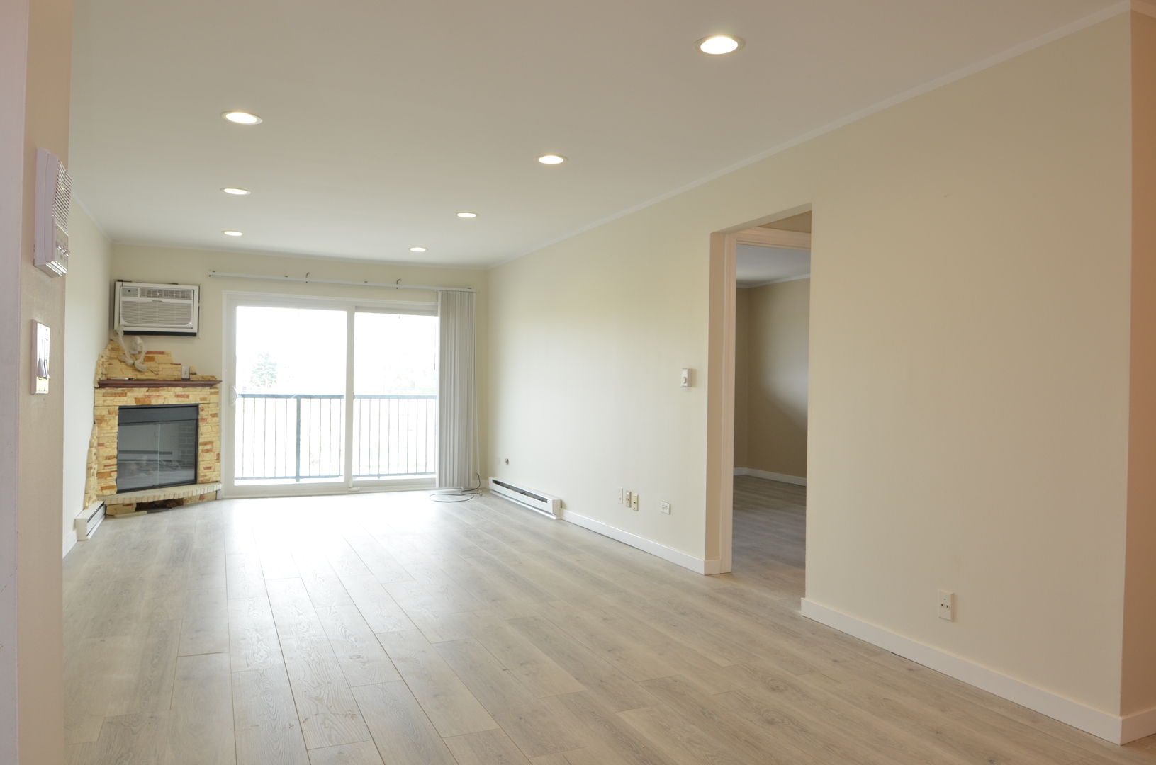 826 East Old Willow Road, Unit 206 Prospect Heights, IL 60070 - Photo 2 of 15 an empty room with wooden floor and a window