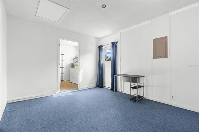 a view of empty room with furniture