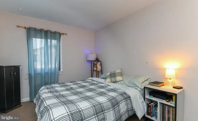 a bedroom with a bed and a bookshelf