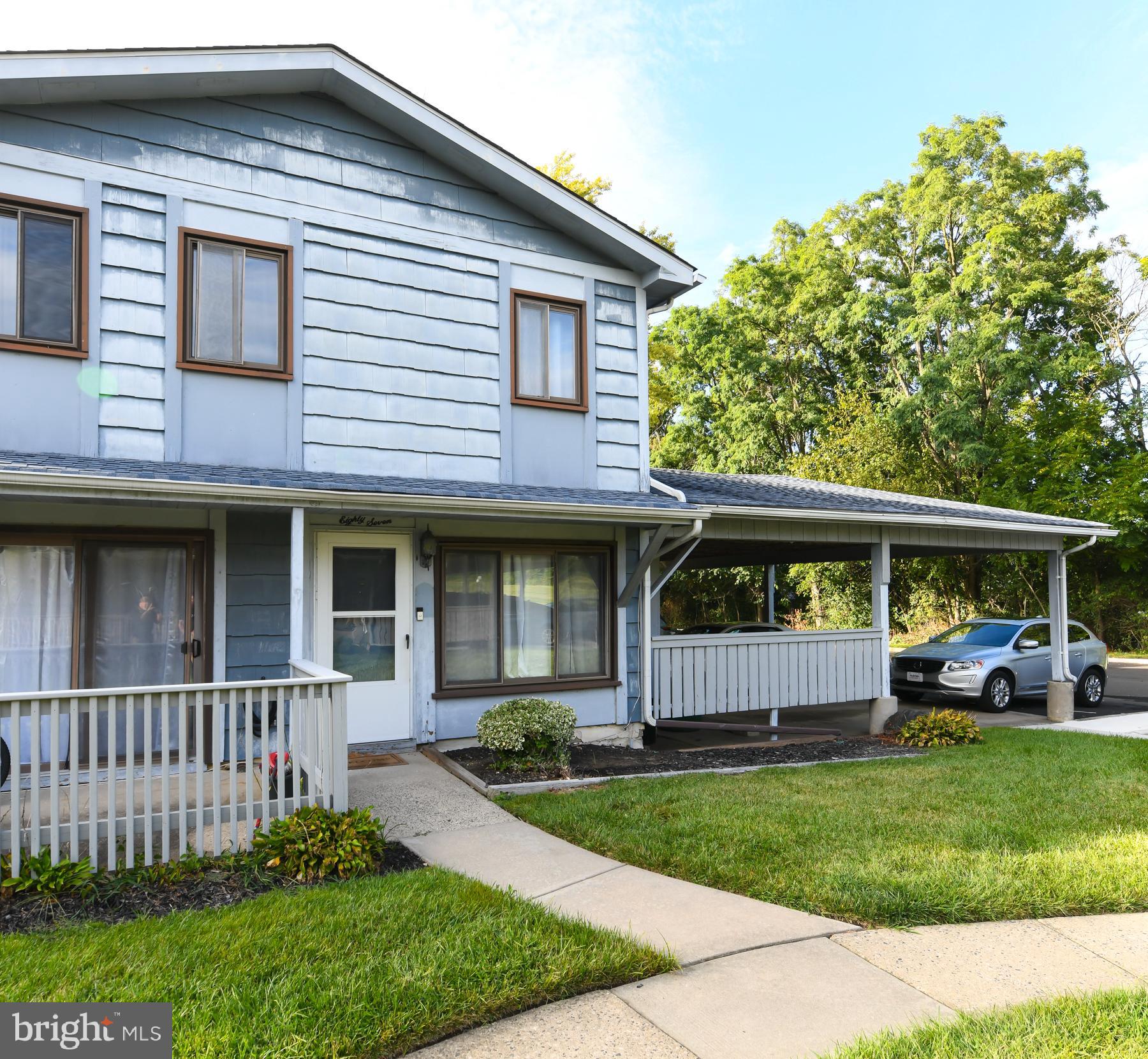 87 Woodway Drive West Deptford, NJ 08066 - Photo 2 of 18 a front view of a house with a garden and plants