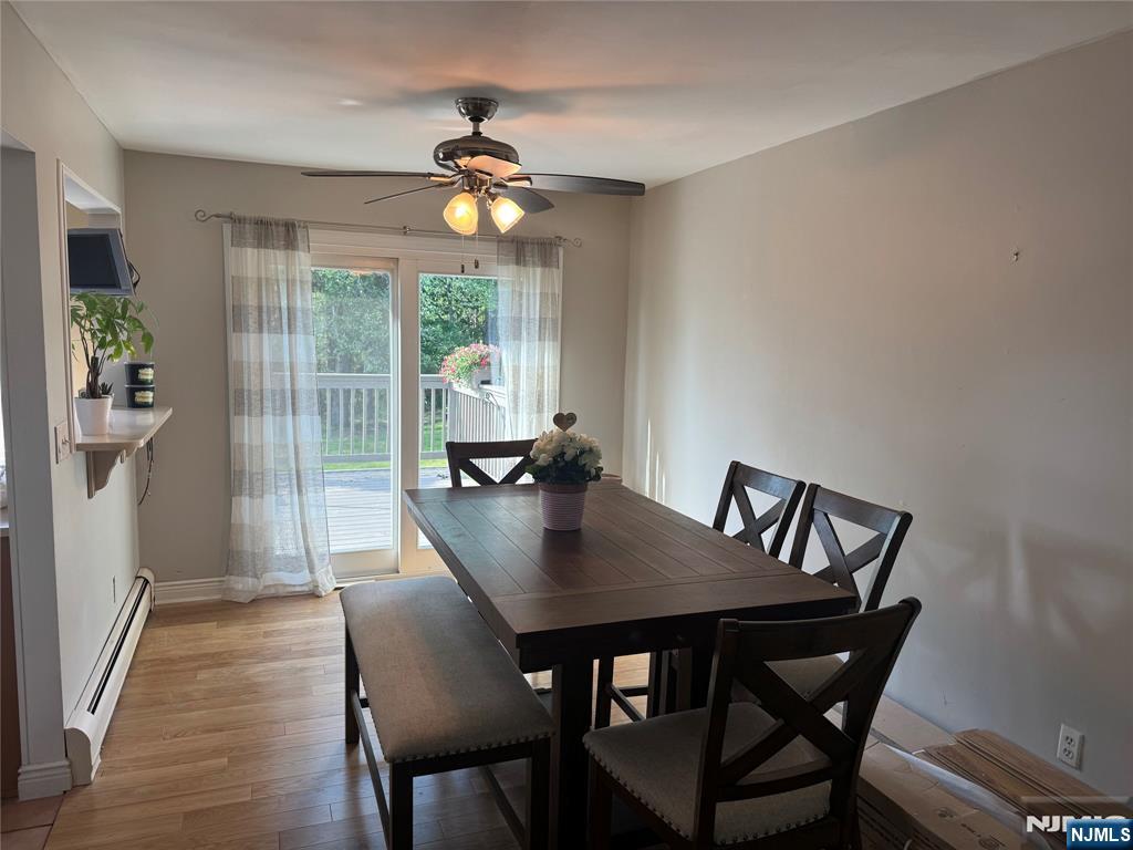 55 Maryann Road Oak Ridge, NJ 07438 - Photo 3 of 20 a view of a dining room with furniture wooden floor and a chandelier