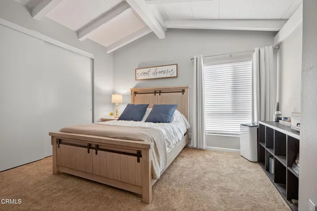 a bed sitting in a bedroom next to a window