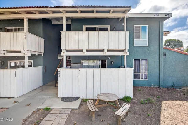 a view of wooden house with large windows and a table