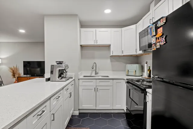 a kitchen with stainless steel appliances a sink stove and cabinets