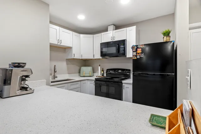 a kitchen with a refrigerator stove and a sink