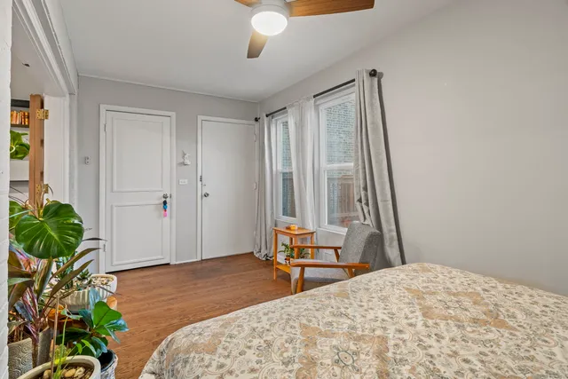 a bedroom with a bed and a potted plant