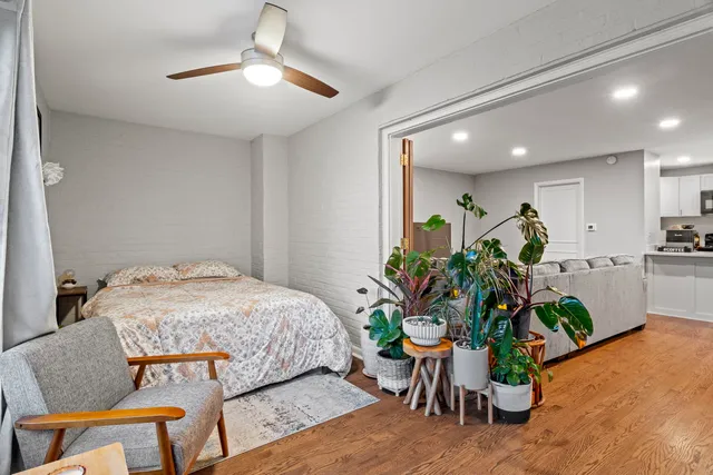 a bed room with furniture and a potted plant