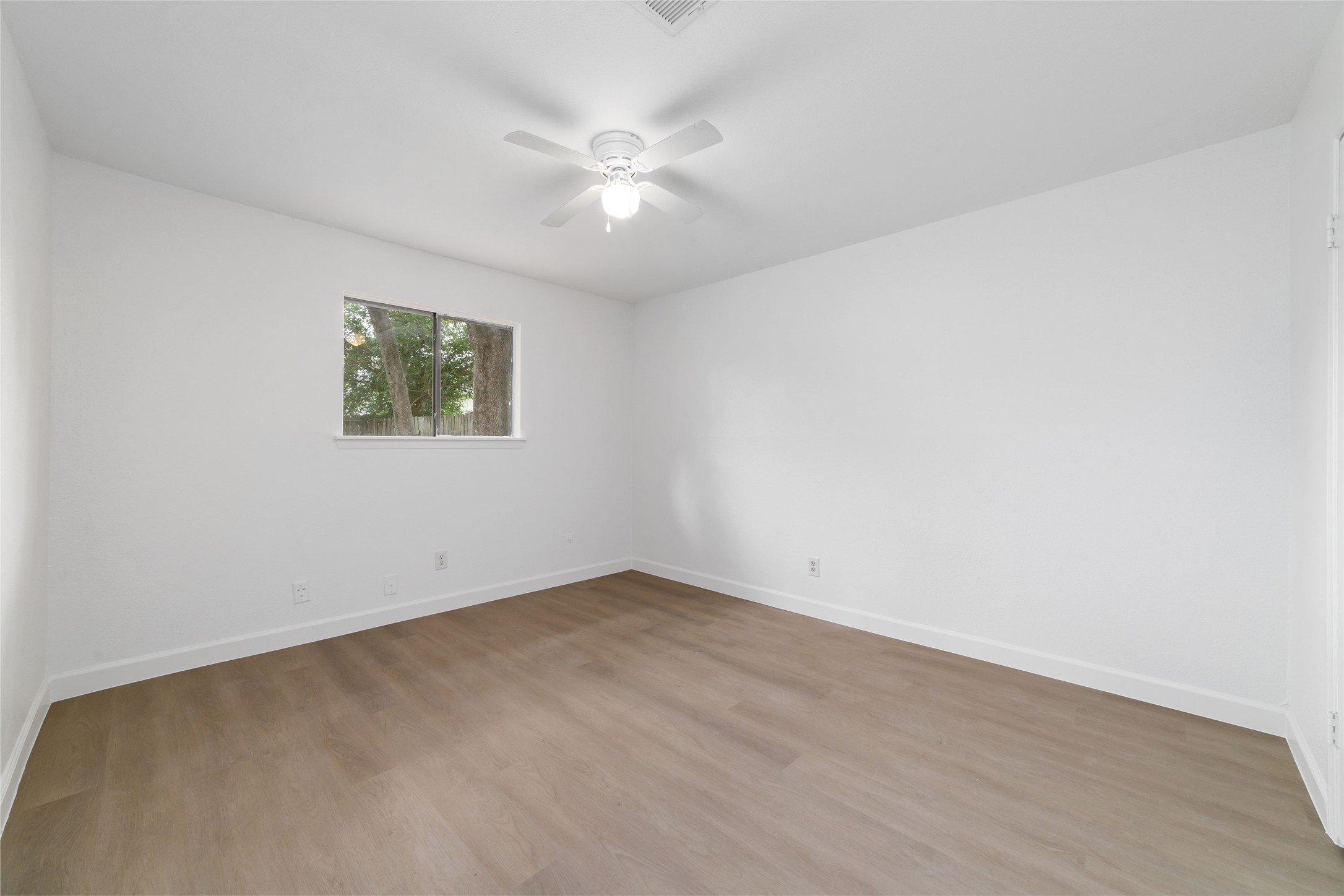 5023 Monteith Drive Spring, TX 77373 - Photo 16 of 20 Comfortable bedroom with a ceiling fan and window that allows natural light to pour in, offering a simple and functional layout.