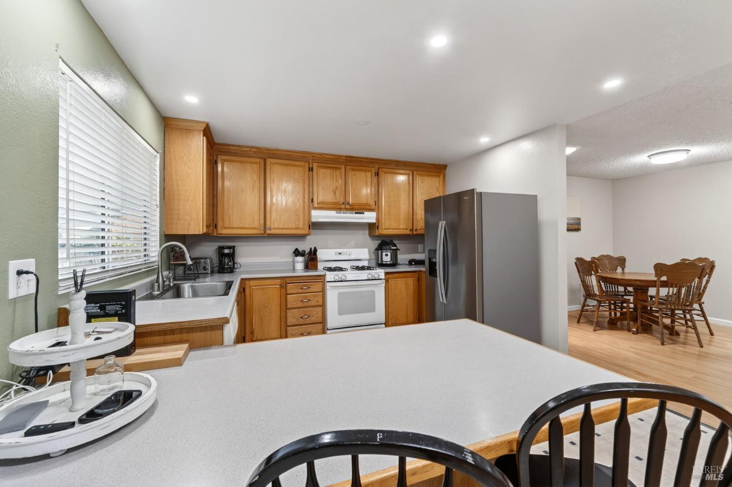 4526 Hillview Court Rohnert Park, CA 94928 - Photo 9 of 28 a kitchen with sink refrigerator dining table and chairs