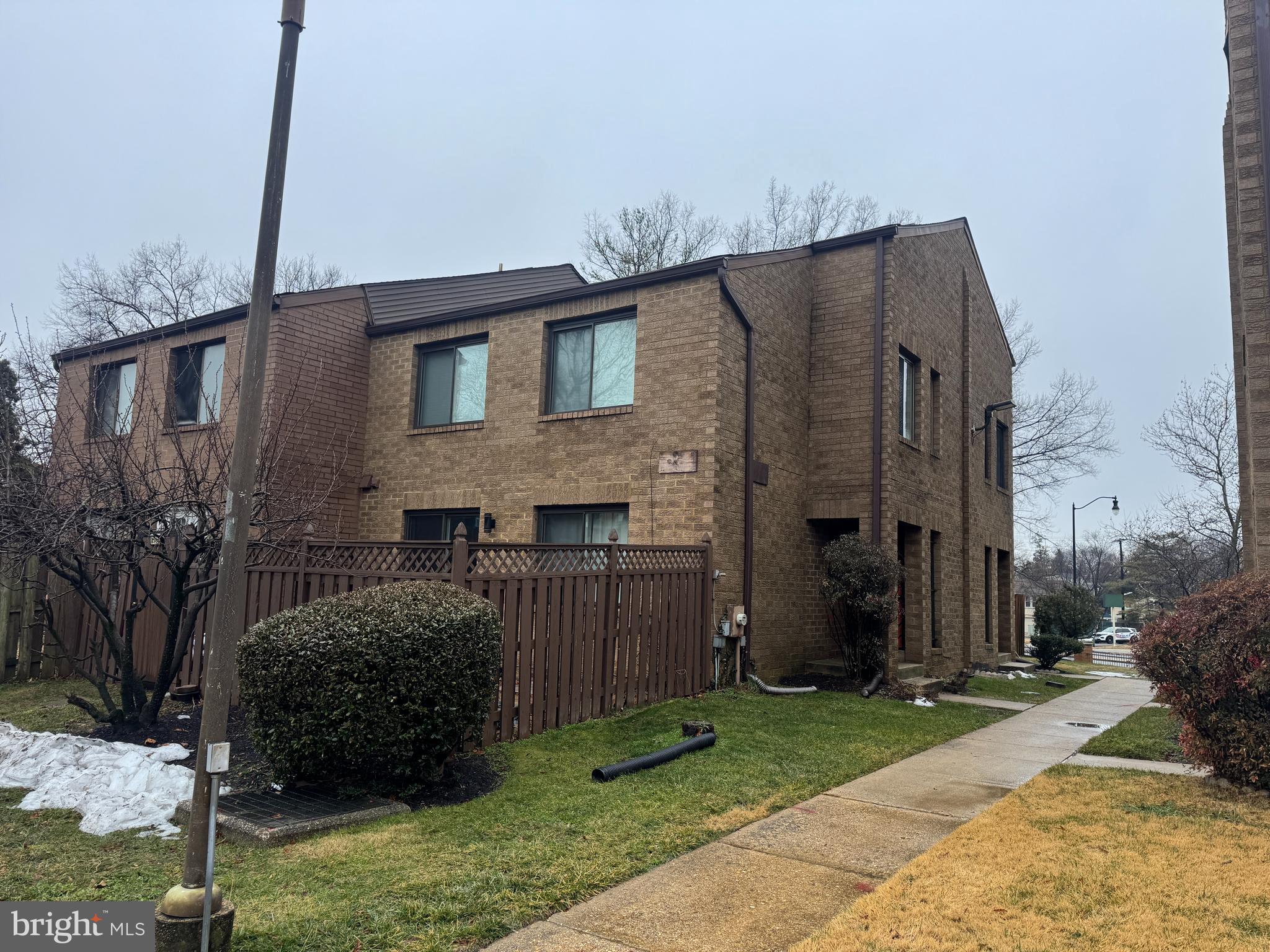 3106 Berry Road Northeast, Unit 20 Washington, DC 20018 - Photo 2 of 3 a brick house that has tree in front of it