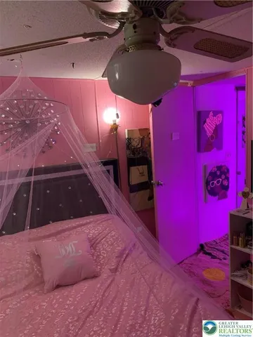 a bed sitting in a bedroom next to a window