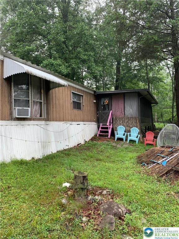 127 Pine Cone Trail Scotrun, PA 18355 - Photo 20 of 24 a view of backyard with barbeque grill and wooden fence