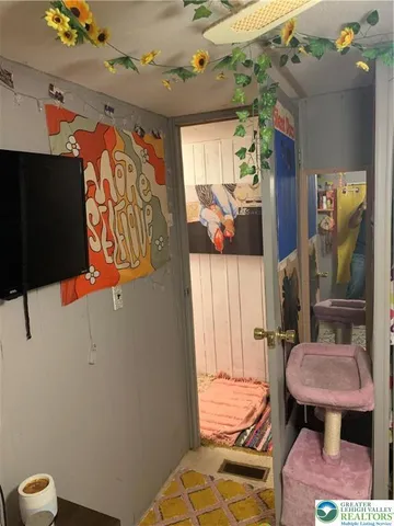 a bathroom with a toilet and a shower curtain