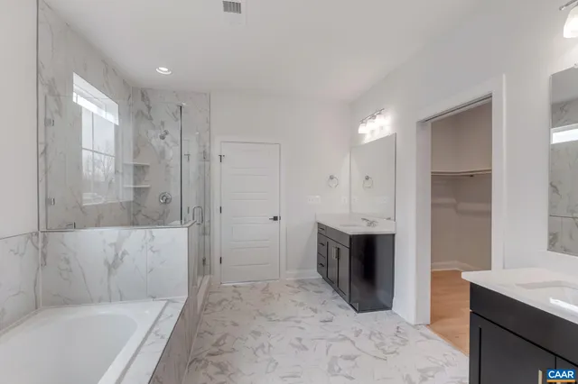a bathroom with a tub shower and sink