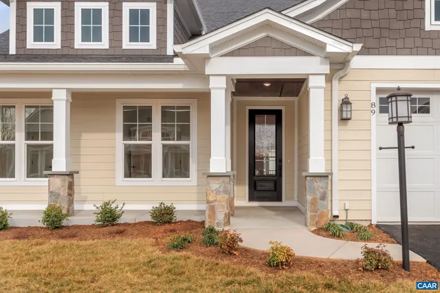 front view of a brick house with a large window