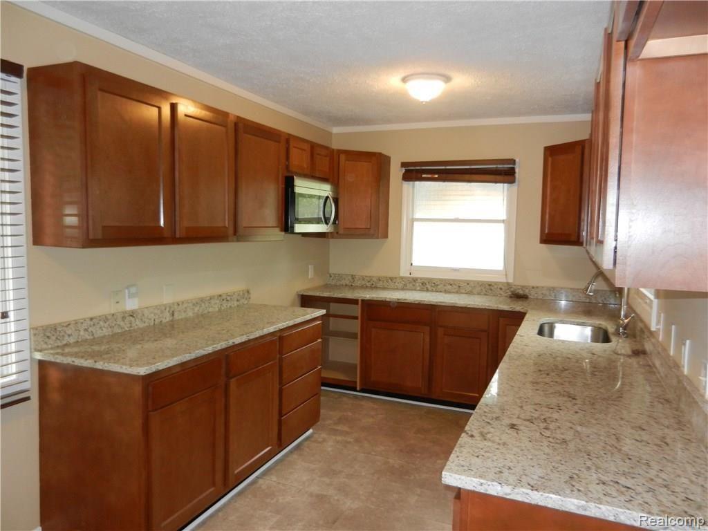 8956 Davisburg Road Clarkston, MI 48348 - Photo 16 of 38 Kitchen with granite counters & laminate flooring.JPG