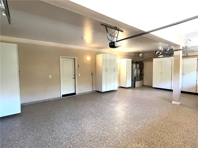 an empty room with windows and fireplace