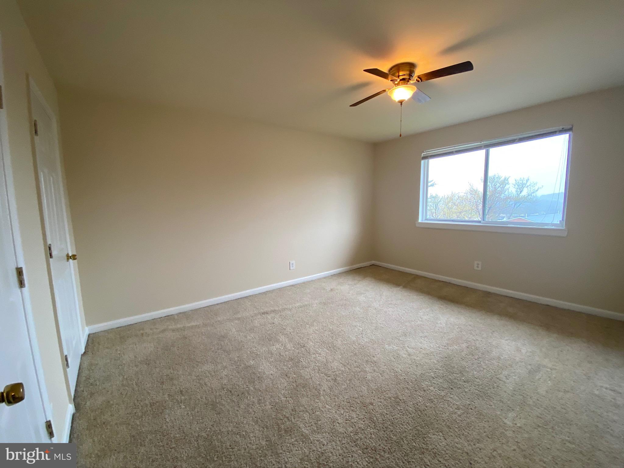 7514 Hawthorne Street, Unit 5 Landover, MD 20785 - Photo 13 of 16 an empty room with windows and fan