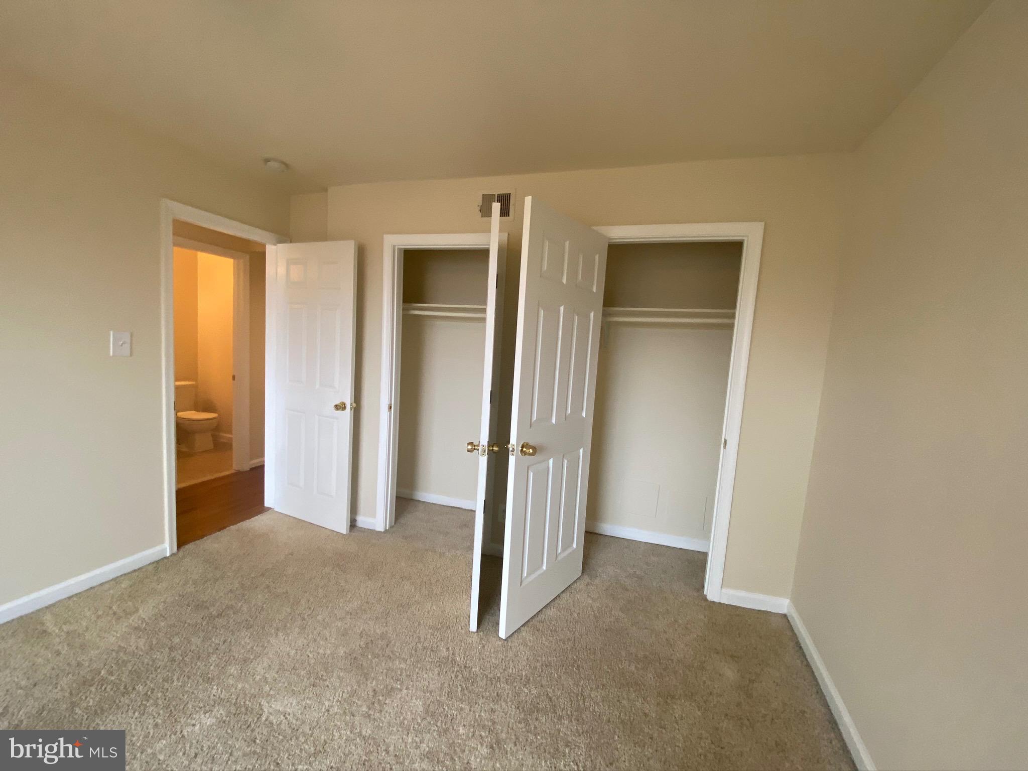 7514 Hawthorne Street, Unit 5 Landover, MD 20785 - Photo 14 of 16 an empty room with closet and wooden floor