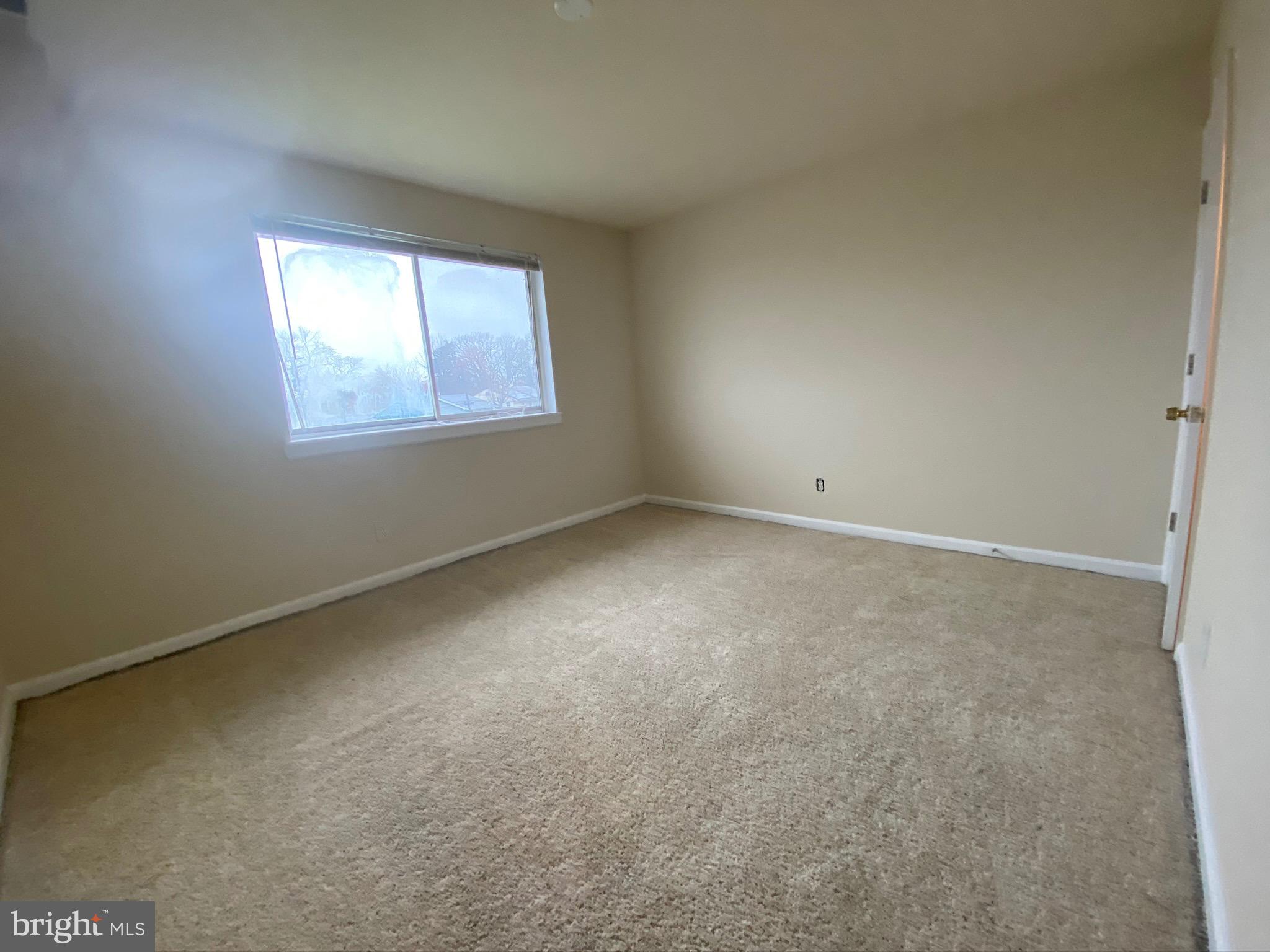 7514 Hawthorne Street, Unit 5 Landover, MD 20785 - Photo 10 of 16 an empty room with a window