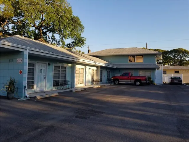 a red car parked in front of a building