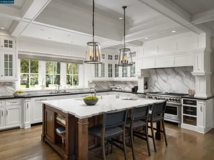 a kitchen with a stove a table and chairs in it