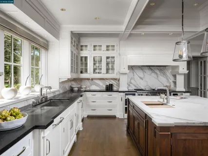 a kitchen with a sink stove and cabinets