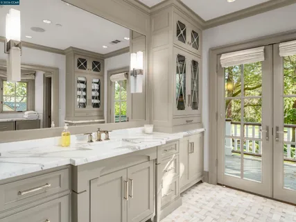 a spacious bathroom with a granite countertop sink and a mirror