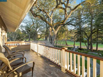 a view of balcony with wooden floor and outdoor seating