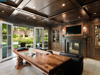 a living room with pool table flat screen tv and windows