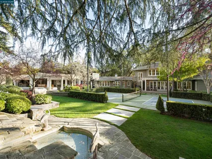 a view of an house with swimming pool and sitting area