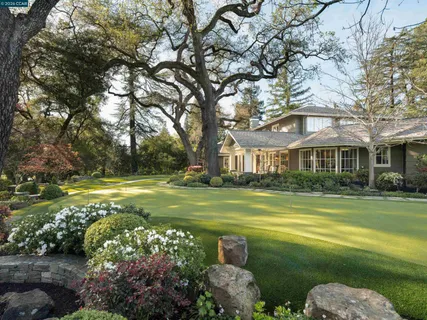 a front view of a house with swimming pool having outdoor seating