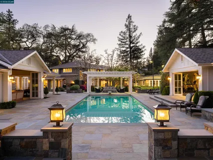a view of a house with swimming pool and a yard
