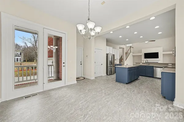 a view of a kitchen with a sink and dishwasher a refrigerator with wooden floor