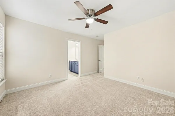 an empty room with closet and windows