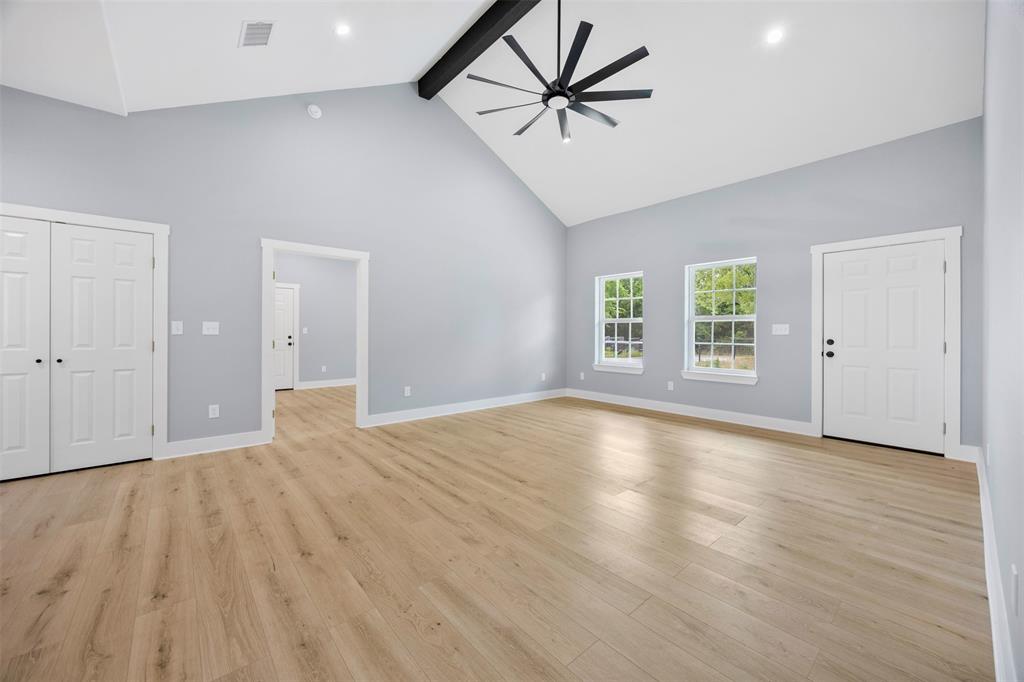 121 Brazier Road Ennis, TX 75119 - Photo 6 of 31 wooden floor in an empty room with a window