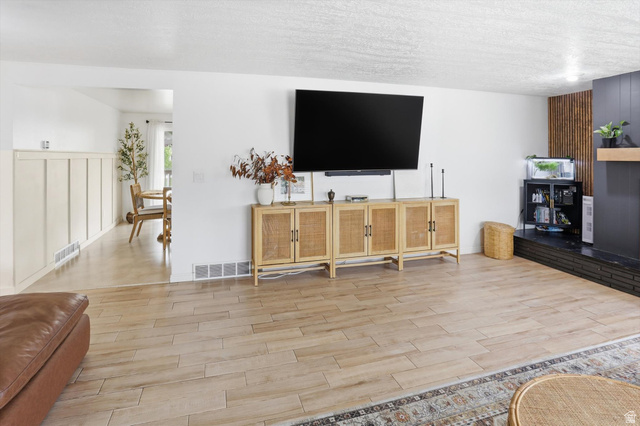 5108 South 2000th Street West Roy, UT 84067 - Photo 9 of 61 Living room featuring wood finish floors and a textured ceiling
