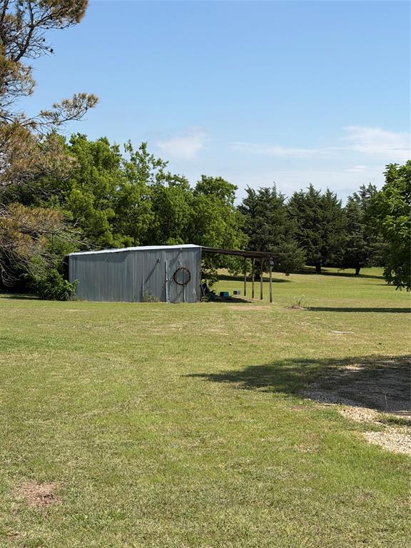 8041 Highway 11 Whitewright, TX 75491 - Photo 4 of 14 a view of a swimming pool with an outdoor seating and a yard