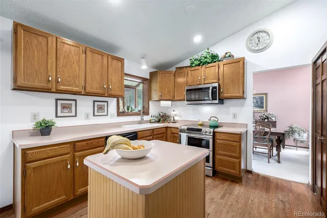 a kitchen with stainless steel appliances granite countertop a sink stove and microwave