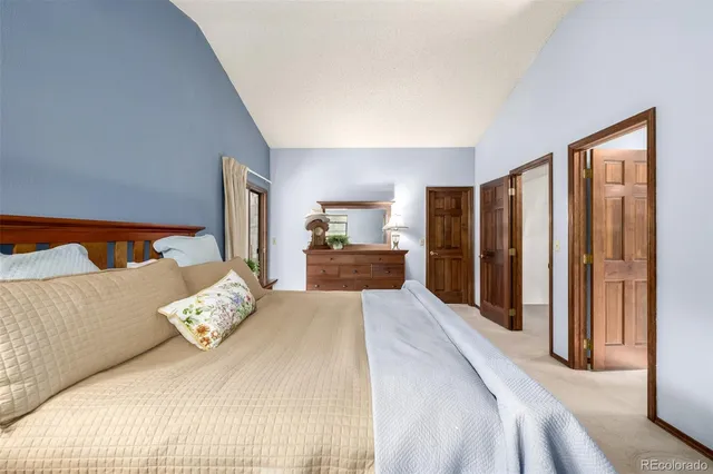 a spacious bedroom with a bed and a large mirror