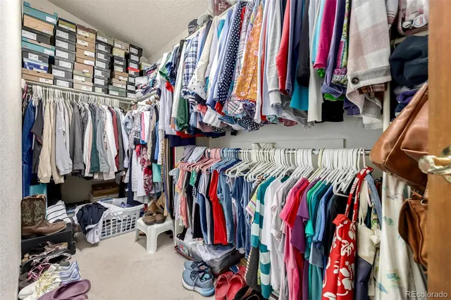 a view of walk in closet with clothes