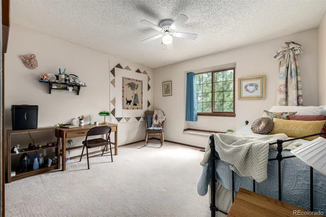 a bedroom with furniture and a large window