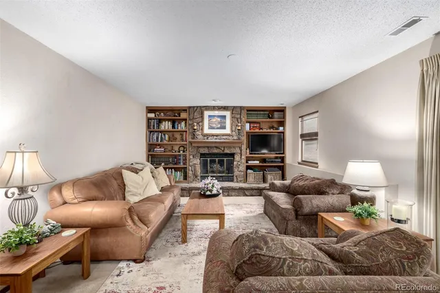 a living room with furniture and a lamp