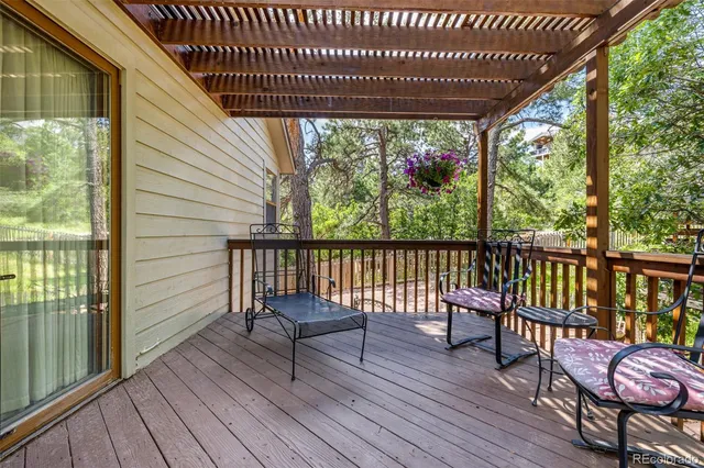 a view of balcony with wooden floor and outdoor seating