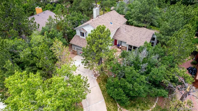 an aerial view of a house with a yard and garden
