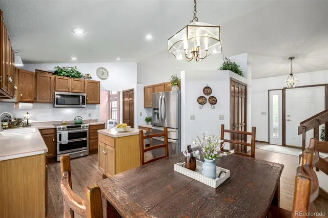 a living room with stainless steel appliances kitchen island furniture and a view of kitchen