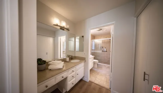 a bathroom with a double vanity sink and a mirror