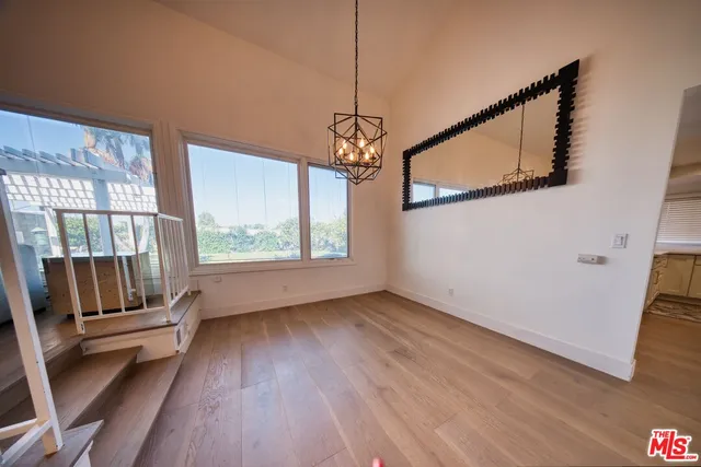 a view of entryway with wooden floor and door