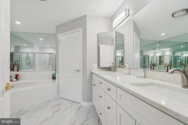a bathroom with a tub sink and mirror