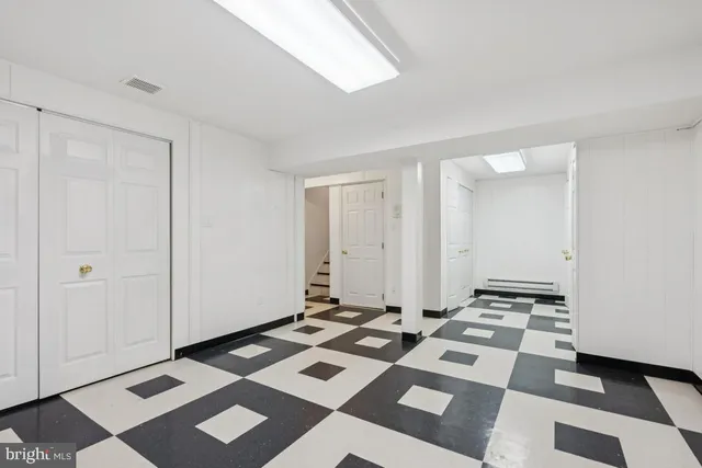 a view of a room with a black white checkered floor